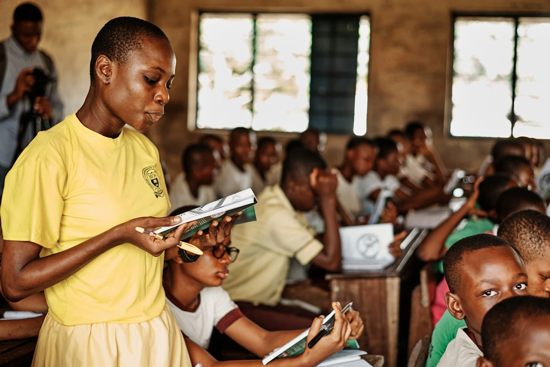 A teacher reviewing a student's notebook in an LCF-supported classroom